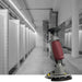 Grey bathroom with red and grey push scrubber in the front