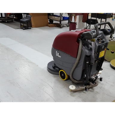 clean white floor Line that has been cleaned by the e20 floor scrubber in dirty work shop setting.