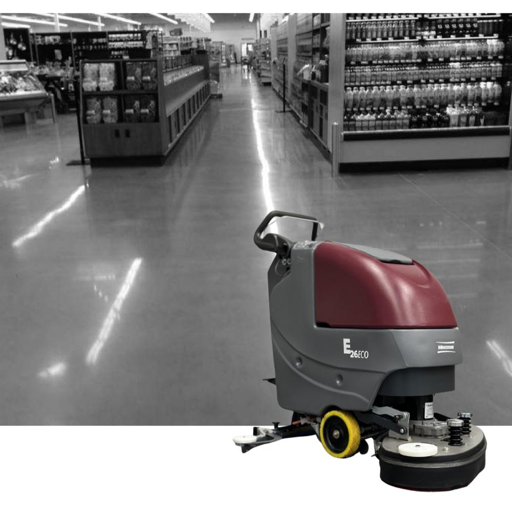 Picture of a grey image that shows isles in a grocery store with the eco 26 floor scrubber in front of it. 