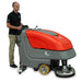 Man with black polo and khaki pants pushing powerboss e3030 medium sized floor scrubber. 