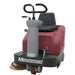 Front view of minute man kleen sweep 32R riding sweeper showing black seat with chrome foot controls and a grey steering console. 