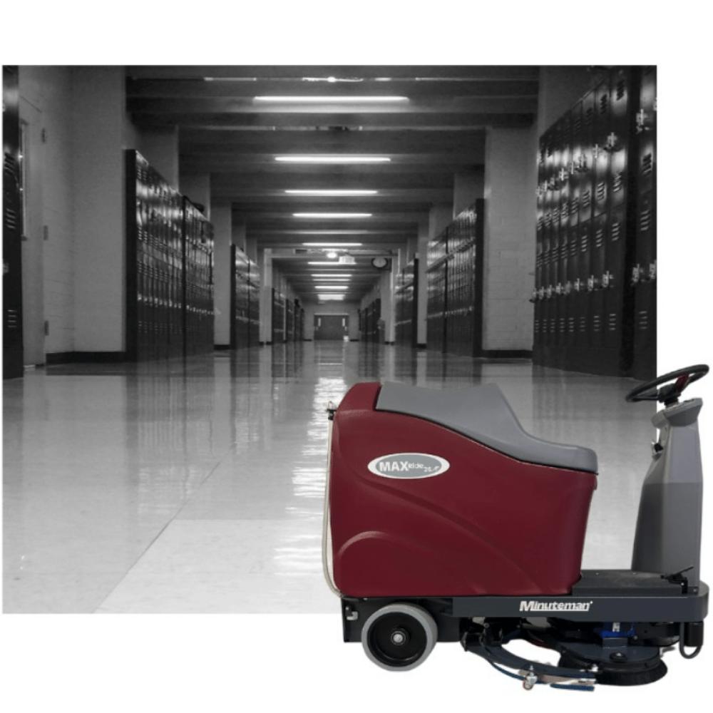 Background Picture of grey school hallway with Minute man Max 26 in front of it.