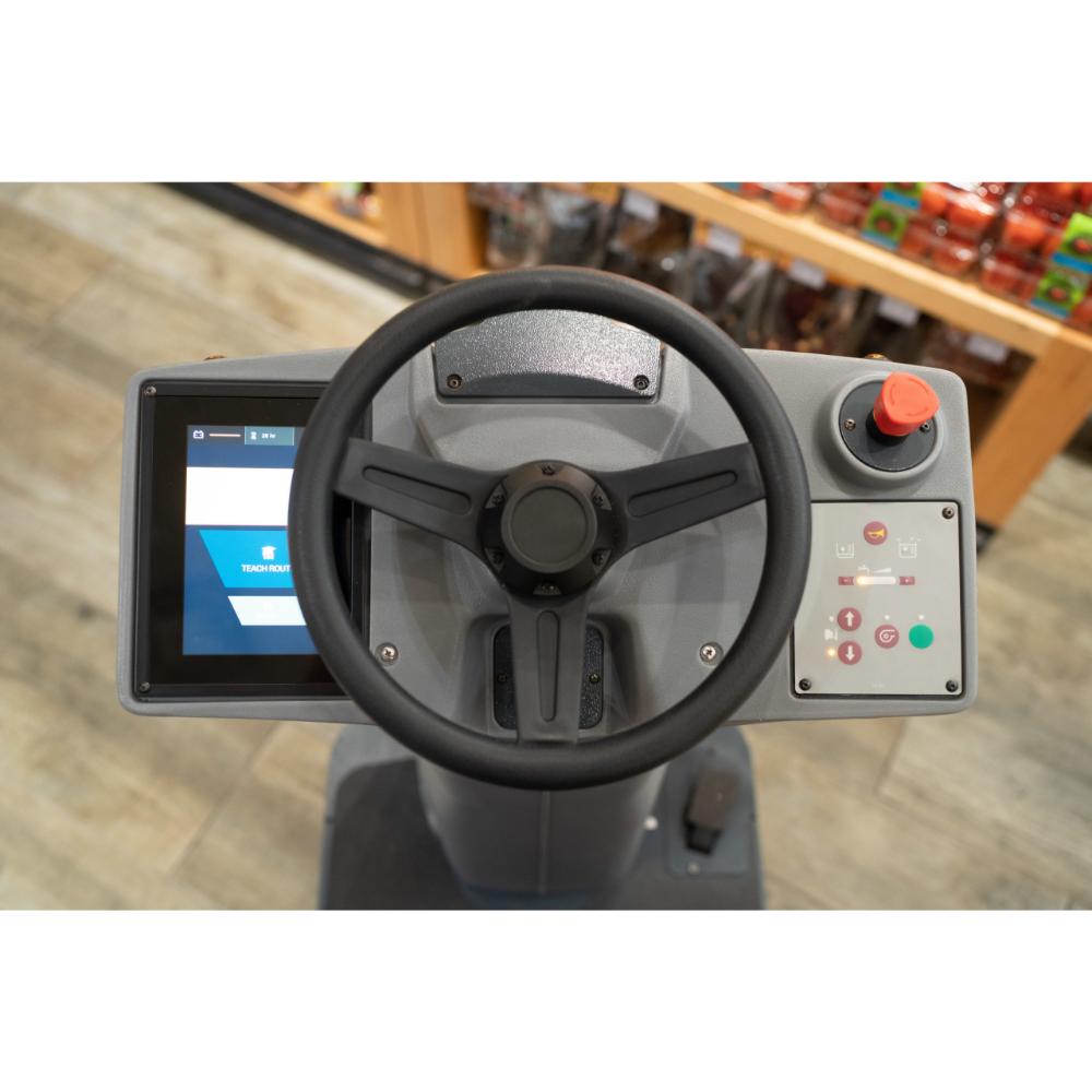 Control console with black wheel of the Minute Man Roboscrub showcasing configuration switchs and screen.