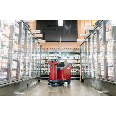 Minute man Autonomus RoboScrub in the middle of the well-lit freezer isle of a grocery store.