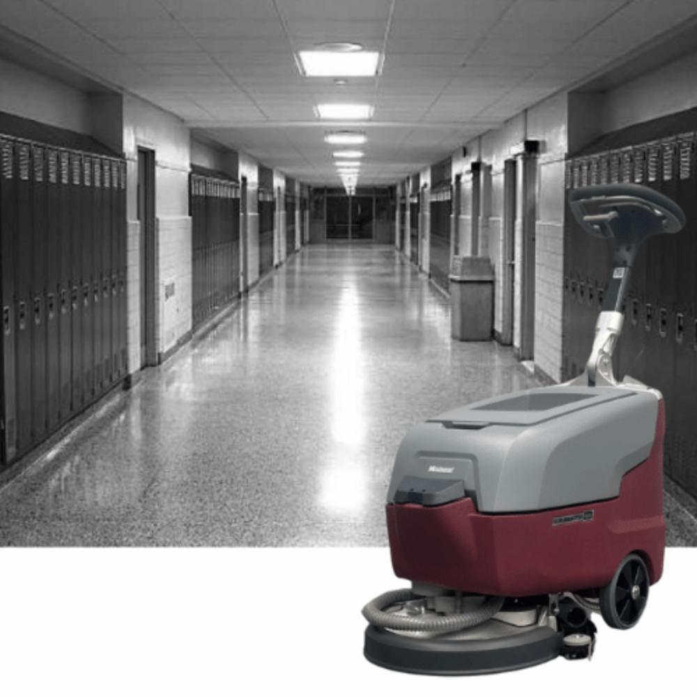 Picture of a Grey school hallway with b25 being showcased in front of the picture. 