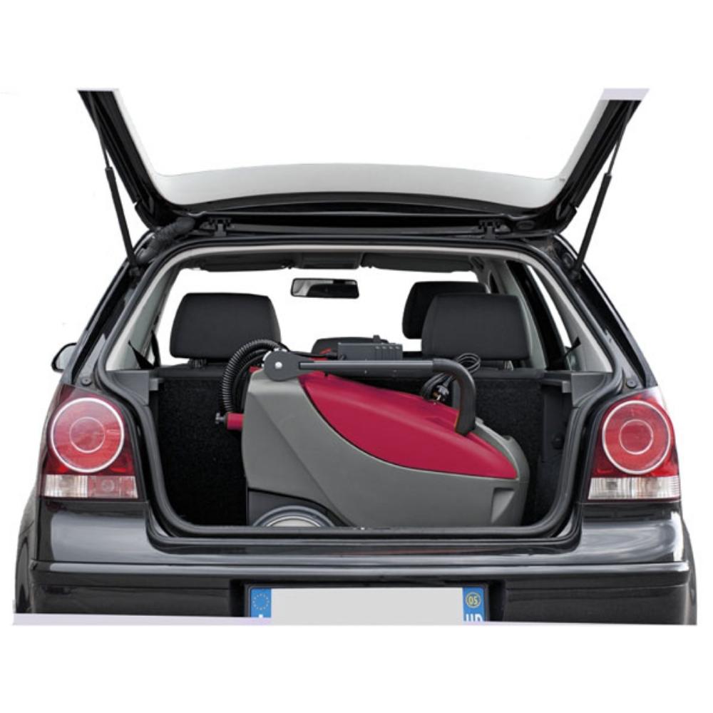 MinuteMan E14 Floor Scrubber folded up in the trunk of a compact black car.