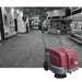 MinuteMan Kleen Sweep 25W Front Red and gray floor cleaning machine in a public building setting