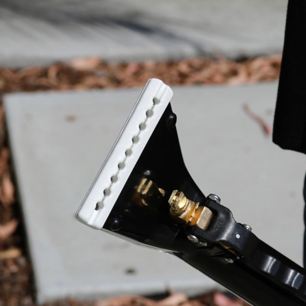 Close-up of carpet wand with a white rubber blade on a blurred background
