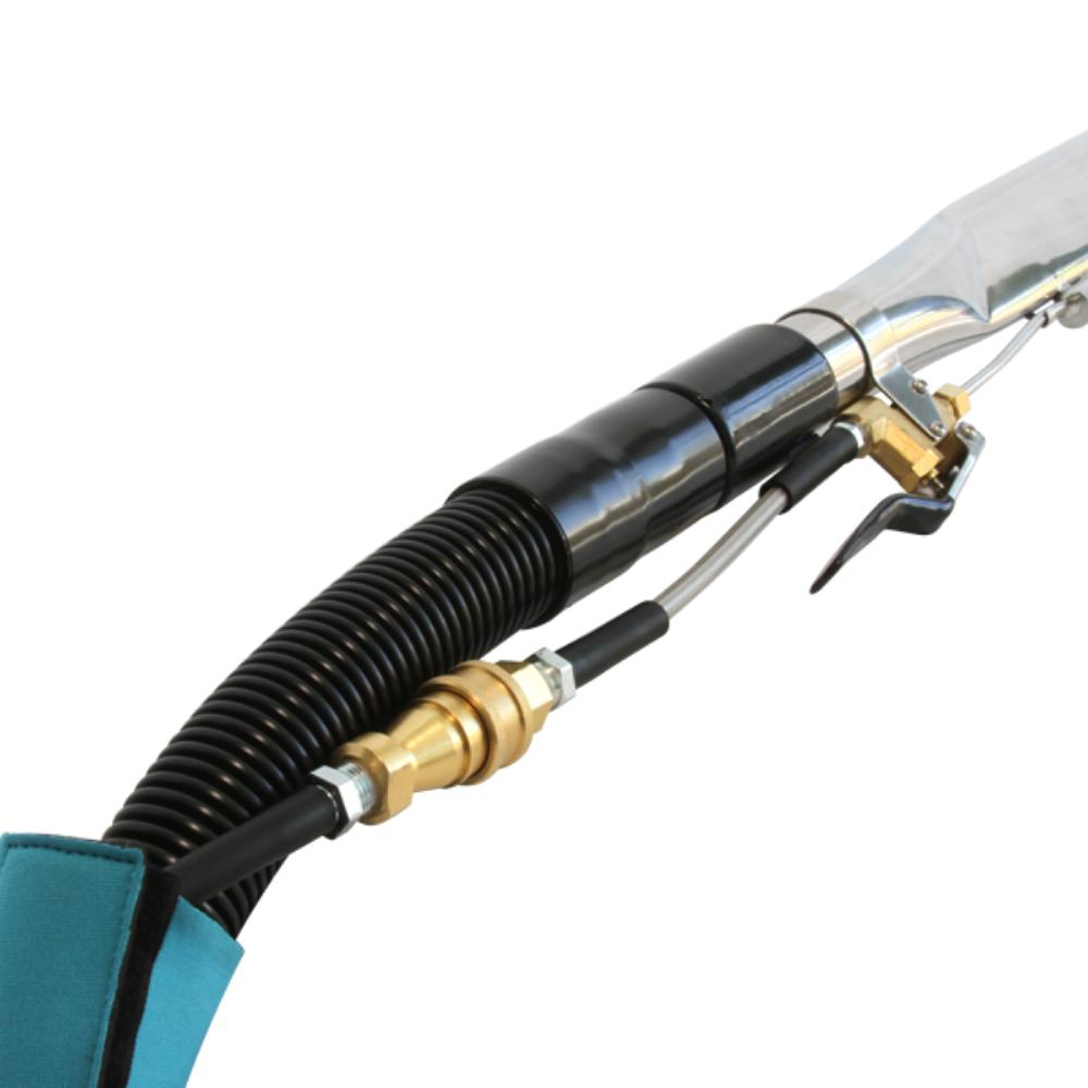 Close-up of a high-pressure washer nozzle with black hose and gold fitting on a white background