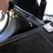Car interior with a hand using a tool to remove a panel.