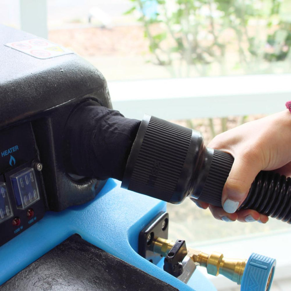 Person using a pressure washer with a nozzle attachment, outdoors.