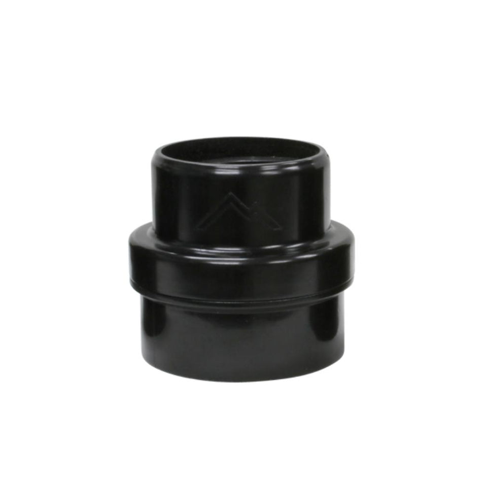 Black plastic pipe fitting on a white background