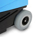 Close-up of a blue and black wheelbarrow with a large wheel on a white background