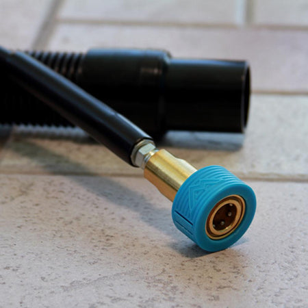 Blue and gold garden hose nozzle on a tiled floor