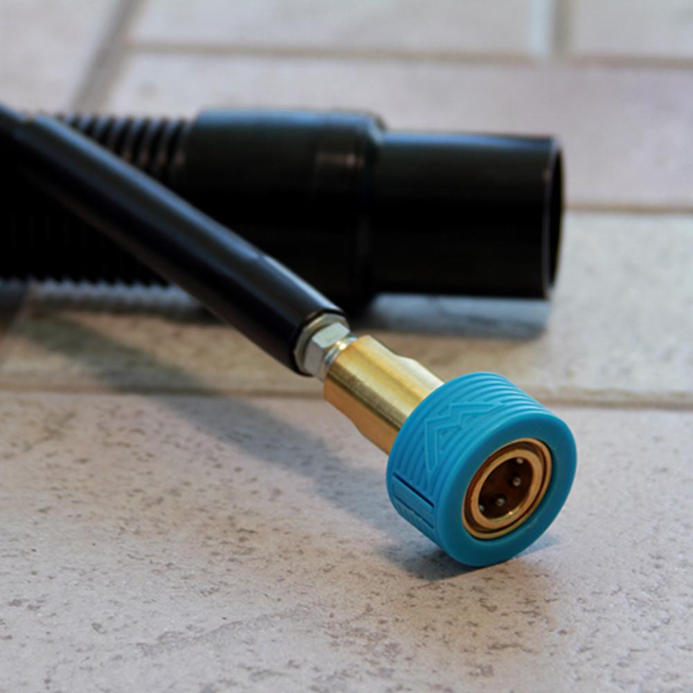 Blue and gold garden hose nozzle on a tiled floor
