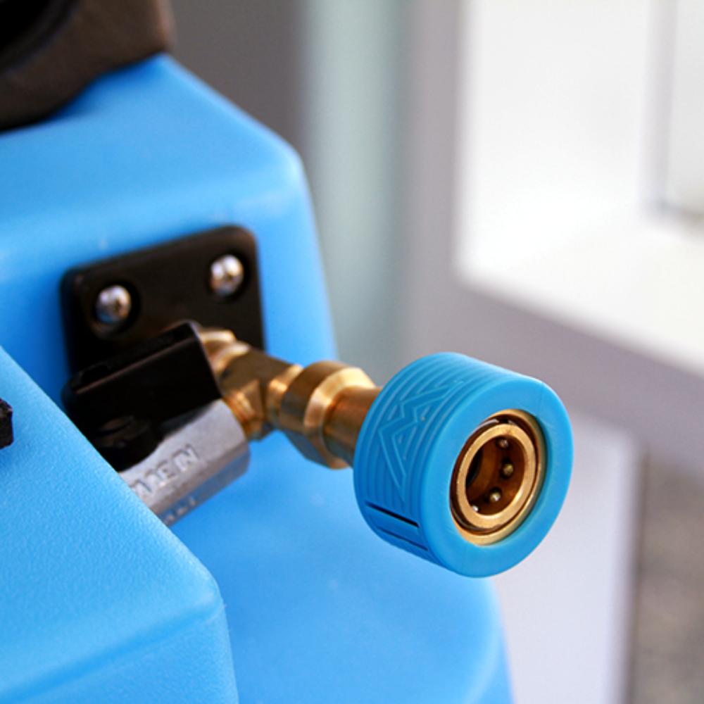 Close-up of a blue and gold pressure washer nozzle.