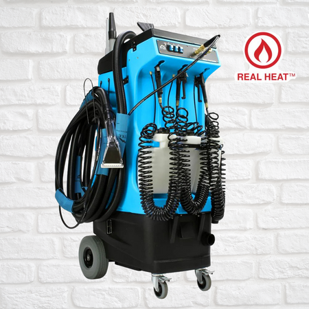Mytee_80-120 Blue and black industrial machine with hoses on a white brick wall background, featuring 'Real Heat' logo.