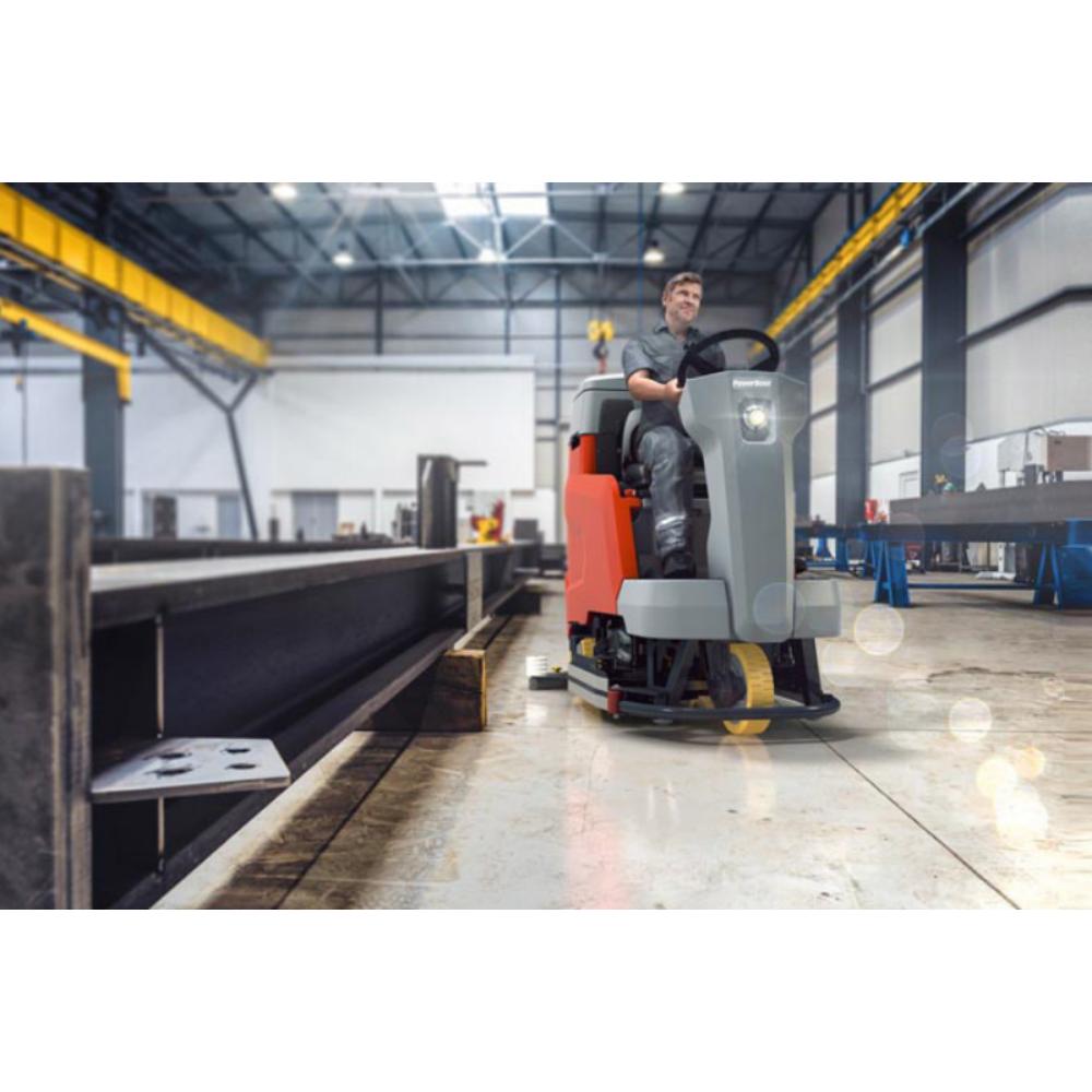 Man Riding orange and grey Power boss Scrubmaster b120 in warehouse 