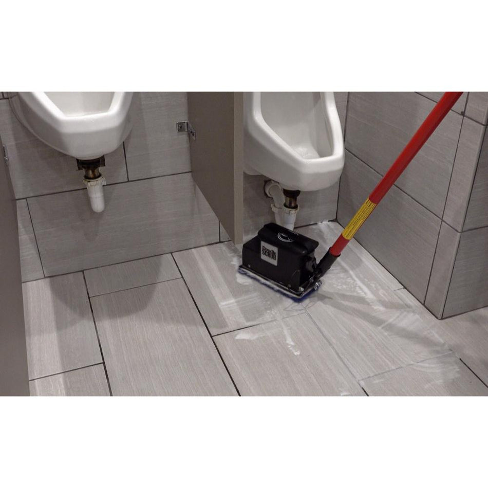 Doodle-Scrub-EBG 9  Floor cleaning machine in a bathroom setting with urinals.