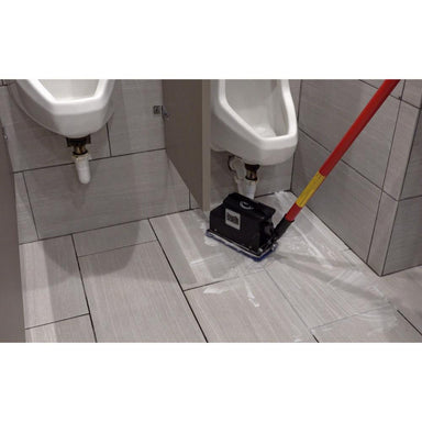 Floor cleaning machine in a bathroom setting with urinals.