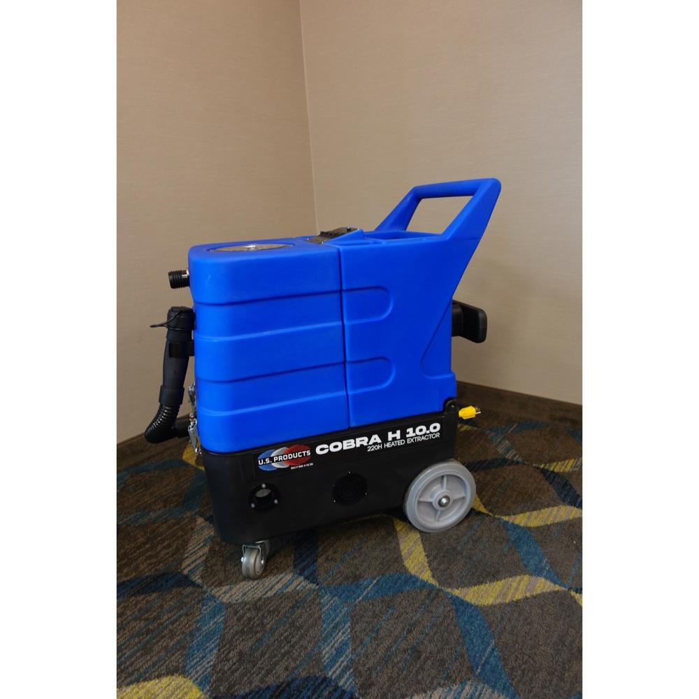 Left side view of U.S. Products Carpet extract displaying logo and small front caster wheels with big back grey wheels.
