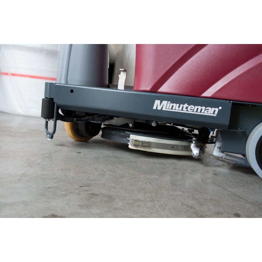 underside scrubbing pad and front steering wheel of minute man max 20 riding floor scrubber.