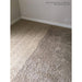 Carpeted room with beige walls and a power outlet.